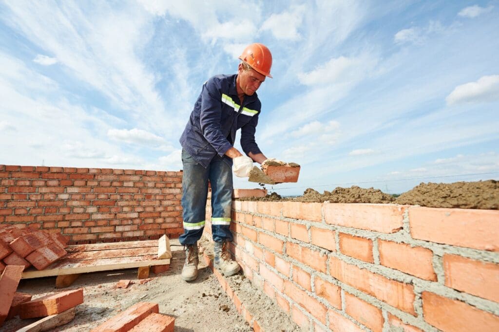 Highland Masonry worker laying bricks